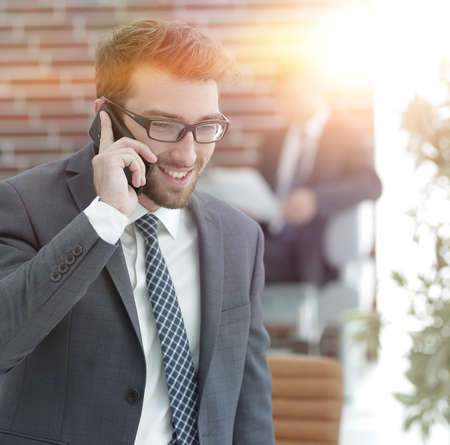 businessman talking on smartphone in his officeの写真素材