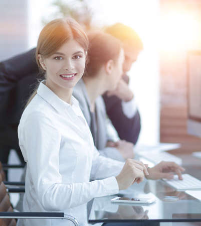 young employee sitting at a Deskの写真素材