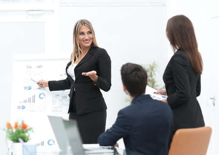 business woman pointing a pointer on a flipchart