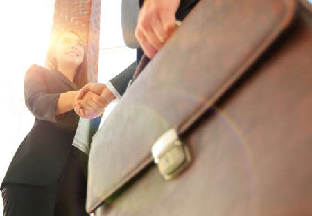 Close up of businessman and businesswoman shaking handsの写真素材