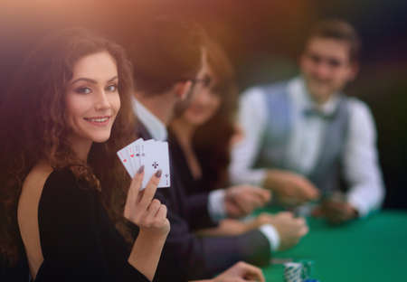 beautiful woman showing a combination of four aces.の写真素材
