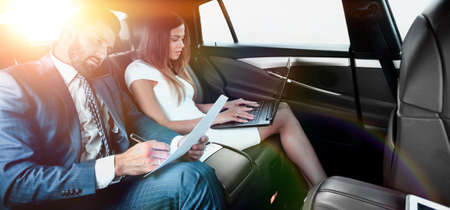 Business trip- Talking on mobile to work of carの写真素材