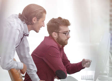 two Caucasian men working on a projectの写真素材