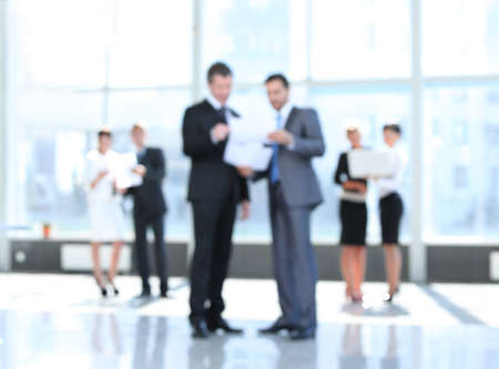 business background.blurred image of business people standing in office.の写真素材