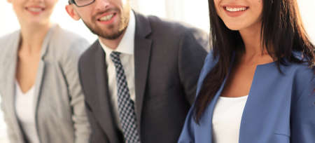 Business woman smiling with her colleagues in the backgroundの写真素材