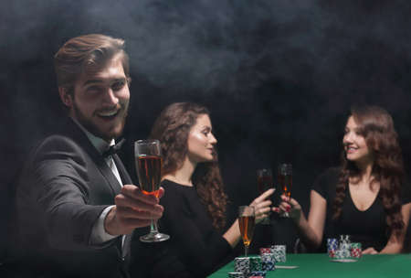 happy group of people celebrating a successful game of poker