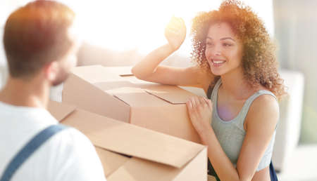 young wife looks at her husband when moving to a new home.の写真素材