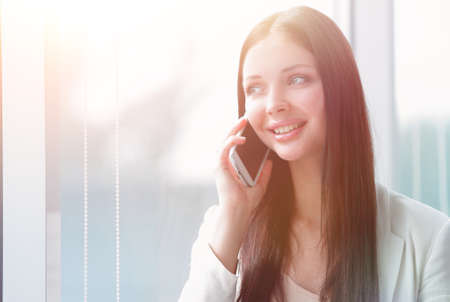 young business woman talking on mobile phoneの写真素材