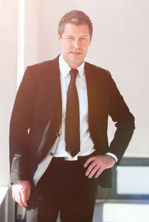 portrait of confident businessman on blurred backgroundの写真素材