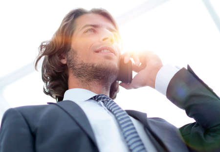 businessman talking on mobile .isolated on white.の写真素材
