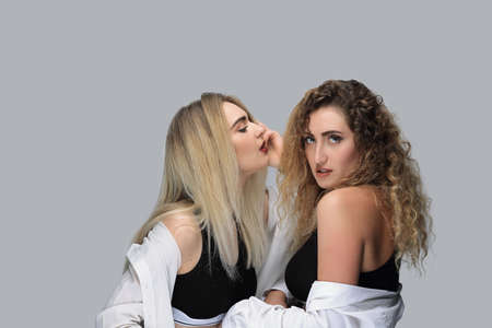 two modern girls in black shirts.の写真素材