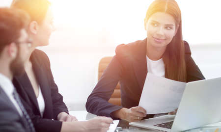 business partners discussing documents and ideas at meetingの写真素材