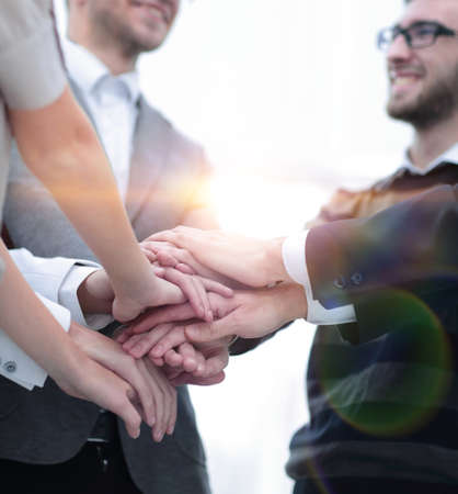 business colleagues with their hands stacked together