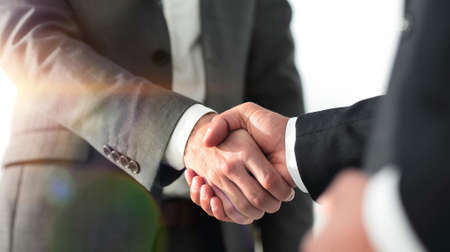 Friendly smiling businessmen handshaking. Business concept photoの写真素材