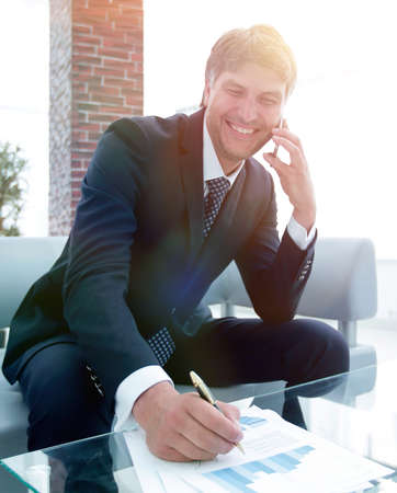 businessman with a smartphone in the workplaceの写真素材