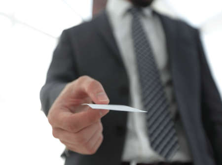 Business man giving business card on bright backgroundの写真素材