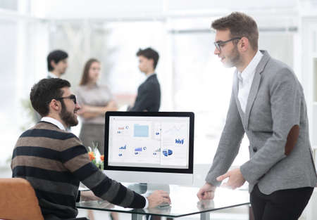 two businessmen analyzing stats financial dataの写真素材