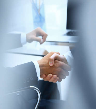 handshake of business partners on blurred background