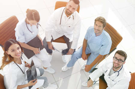 medical staff discussing current issues,sitting behind a Deskの写真素材