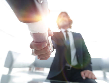 Close-up of two business people shaking handsの写真素材