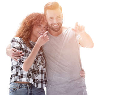 young couple discussing their dreams and pointing forward.の写真素材
