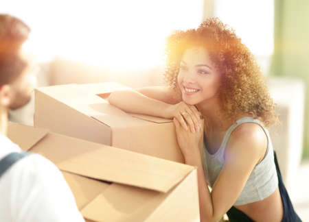 young wife looks at her husband when moving to a new home.の写真素材