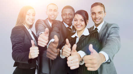 Success and winning concept - happy business team showing thumbsの写真素材