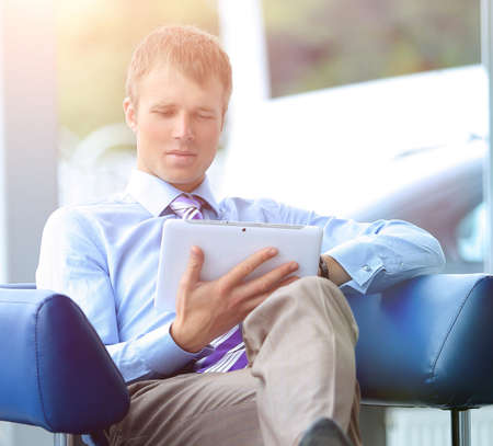 businessman in suit resting in armchair at officeの写真素材