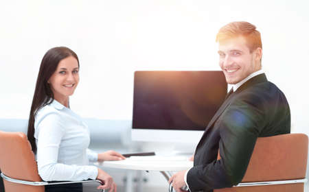 two successful employee sitting behind a Desk
