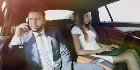 business people using mobile phones and laptop during a trip