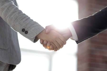 Business people shaking hands isolated on white backgroundの写真素材