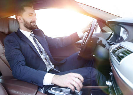 businessman sitting behind the wheel of a carの写真素材