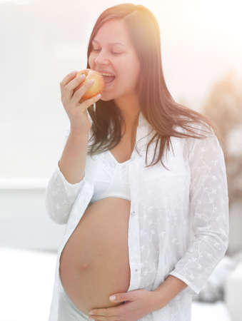 smiling pregnant woman with an Appleの写真素材