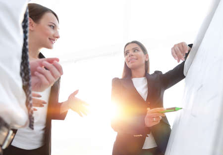 business woman pointing with a marker on the flipchartの写真素材