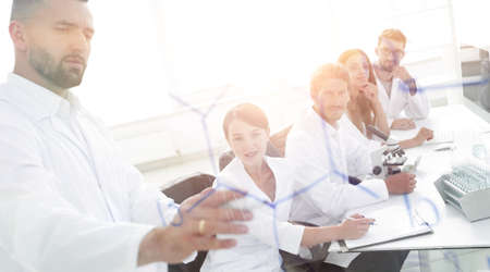 from behind the glass. a scientist standing near the blackboardの写真素材