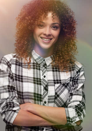 Portrait of an attractive young woman in a plaid shirtの写真素材