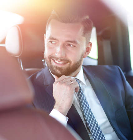 Close-up of a successful businessman sitting in a comfortable car