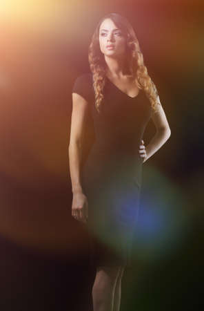 young woman standing on the studio backgroundの写真素材