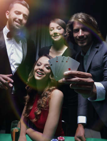 Upper class friends gambling in a casino.の写真素材