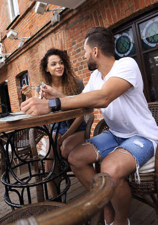 Portrait of lovely romantic couple sitting in a cafe with coffeeの写真素材