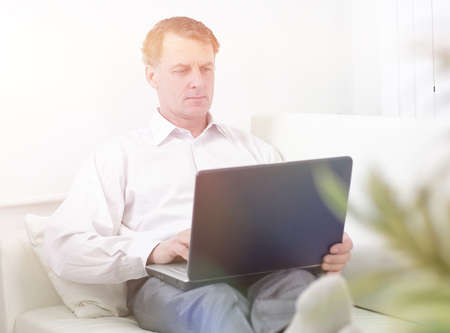 businessman working on laptop while sitting in a hotel room