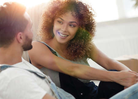 Close-up of newlyweds sitting on the couch in a new apartmentの写真素材