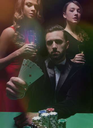 concentrated men and women playing poker in casinoの写真素材