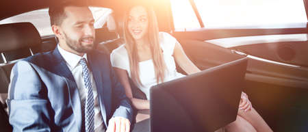 Business man and woman working together in the carの写真素材