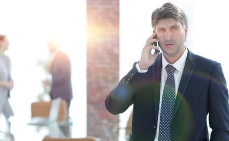 Serious businessman talking on the phone.の写真素材