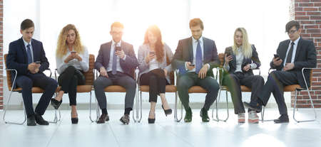 employees using smartphones in the office.