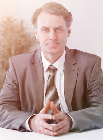 Portrait of businessman sitting at the deskの写真素材