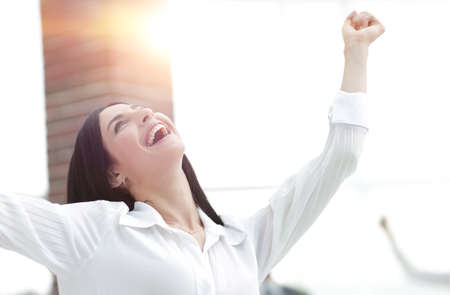 happy young business woman on a blurred office background.の写真素材