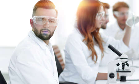 microbiologist and his colleagues are sitting in a modern laboraの写真素材