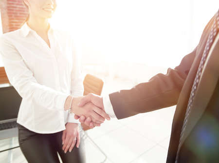 woman Manager welcomes the client with a handshake.の写真素材